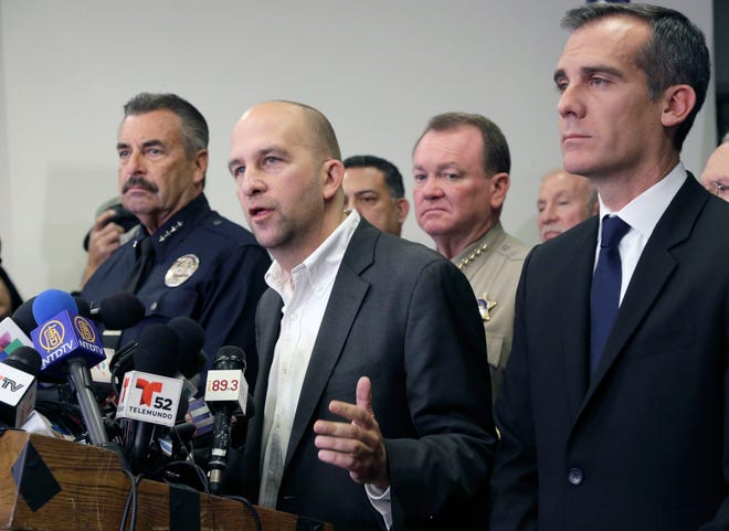 Board of Education President Steve Zimmer, center, Los Angeles Police Chief Charlie Beck, left, and Los Angeles Mayor Eric Garcetti, right, talk to the media after officials closed all Los Angeles Unified School District campuses due to a threat on Tuesday. The shutdown abruptly closed more than 900 public schools and 187 charter schools across Los Angeles. AP Photo/Nick Ut