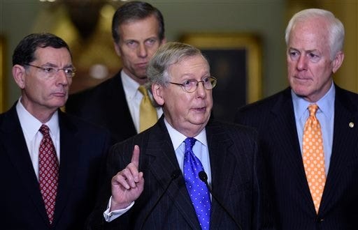Senate Majority Leader Mitch McConnell of Ky., center, accompanied by, from left, Sen. John Barrasso, R-Wyo., Sen. John Thune, R-S.D., and Senate Majority Whip John Cornyn of Texas, speaks during a news conference on Capitol Hill in Washington, Tuesday, Dec. 15, 2015, to discuss budget negotiations. (AP Photo/Susan Walsh)