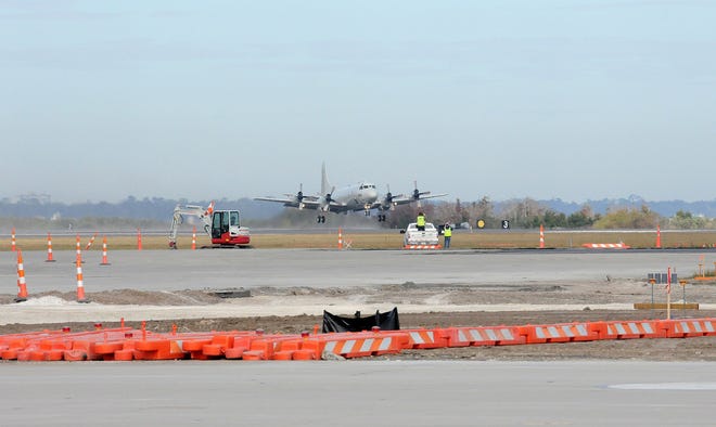 The P-3C Orion flown by Fleet Readiness Center Southeast P-3C Product Officer and Test Pilot Lt. Cmdr. Adam Schantz takes off from the NAS Jax runway on Dec. 9. The aircraft was the first to takeoff from the airfield since it closed for construction in early June.