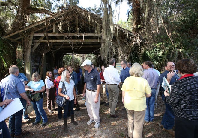 People gather together after a press conference held to announce the purchase of 4,900 acres of forestland in the Silver Springs Forest by the St. Johns River Water Management District in Silver Springs.