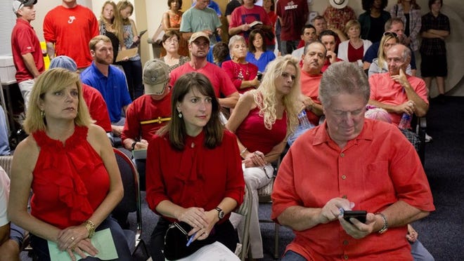 People gather in one of two overflow rooms for the Town Hall meeting in Jupiter on Tuesday. More than 350 people showed up for the meeting, both for and against the proposal to build an outdoor marketplace on a four-acre property on Love Street. (Brianna Soukup/The Palm Beach Post)