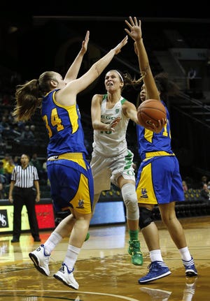 Oregon guard Lexi Bando drives to past as UC Riverside's Clemence Lefebvre, left, and Michelle Curry defend during the fourth quarter of the Ducks' 95-81 non-conference win at Matthew Knight Arena in Eugene on Tuesday, December 15, 2015. Bando scored 17 points in the win that moved Oregon to 9-0 on the season. (Andy Nelson/The Register-Guard)