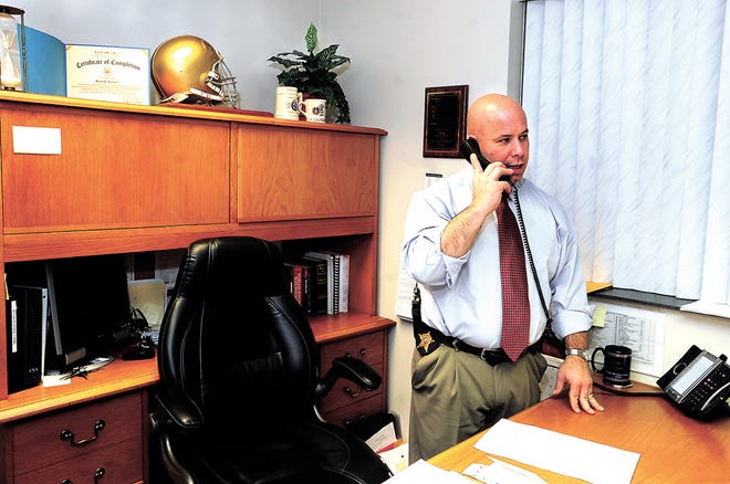 Tuscarawas County Sheriff's Detective Orvis Campbell makes a call from his office in New Philadelphia.