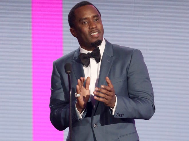 In this Nov. 22, 2015, file photo, Sean Combs presents an award at the American Music Awards in Los Angeles. The veteran music mogul expects to perform on "Pitbull's New Year's Resolution" concert on Fox and will rerelease his recent critically-acclaimed mixtape "Money Making Mitch" through iTunes on Friday. It's the prequel to Puff Daddy's final album "No Way Out 2," which will release next year. (Photo by Matt Sayles/Invision/AP, File)
