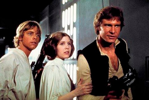 This photo provided by Twentieth Century Fox Home Entertainment shows, Mark Hamill, from left, as Luke Skywalker, Carrie Fisher as Princess Leia Organa, and Harrison Ford as Hans Solo in the original 1977 "Star Wars: Episode IV - A New Hope" film, included in the new Blu-ray release of "Star Wars: The Complete Saga" out on Oct. 13, 2015. The new film, "Star Wars: The Force Awakens," opens in U.S. theaters on Dec. 18, 2015. (Twentieth Century Fox Home Entertainment via AP)