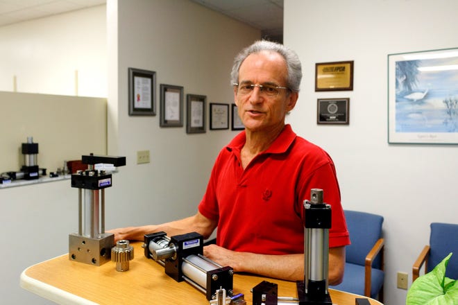 Norman Lane explains the workings of actuactors made by his Ormond Beach company, Rotomation. An interest in education prompted him to volunteer his time to help students compete in robotics competitions. NEWS-JOURNAL/MARK LANE