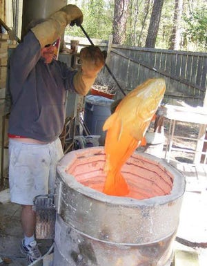 Alan Bennett of Alan and Rosemary Bennett Clay Fish in Bath removes a work of art from a kiln as he does during the Arts in Bloom event every April when artists open their workspaces to curious eyes. PHOTO PROVIDED