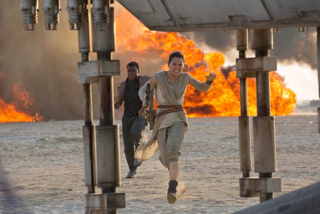 Daisy Ridley, right, as Rey and John Boyega as Finn appear in a scene from the film "Star Wars: The Force Awakens," directed by J.J. Abrams.