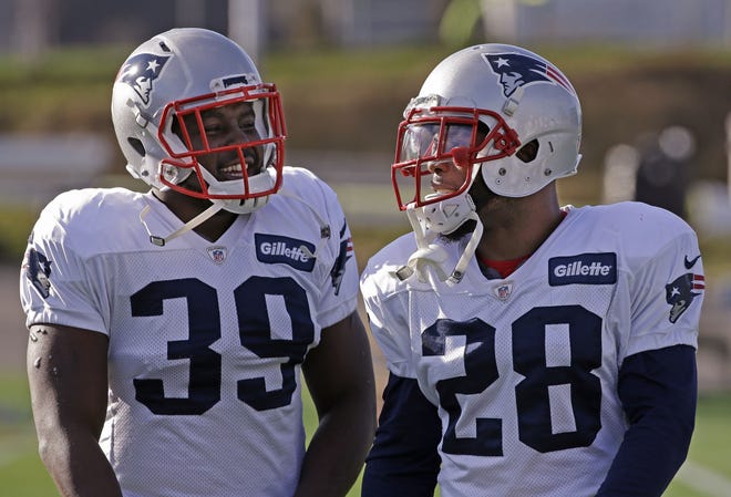 Newly acquired Patriots running back Montee Ball, left, chats with James White during practice on Wednesday. The Associated Press