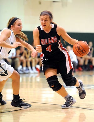 n Hiland High School’s Brittany Miller dribbles around Malvern defender Hunter Martin during Wednesday’s Inter-Valley Conference matchup at Malvern. The Hawks won 84-50.