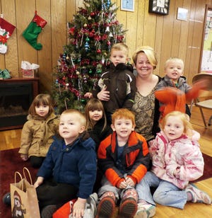 At the Clarksville Area Library, Ms. Nikki read "Ten Tiny Gingerbread Men" by Tiger Tales and helped patrons make decorations for gifts. Join the fun next year starting Thursday, Jan. 7 for Story Time 10:15 a.m. at the Village Hall with Ms. Sheila. Pictured are, back: Logan and Kendall Clum, Levi Batchelder and Nikki Weitting, Shane Buche; and front: Simon Wells, Cole Denney and Lacey Carnahan.