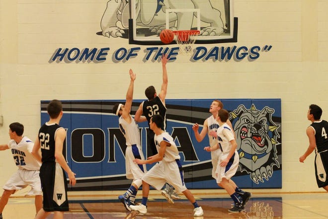 Williamston's Kurtis Kodet goes up for a shot against a trio of Bulldogs in the second half on Friday night.