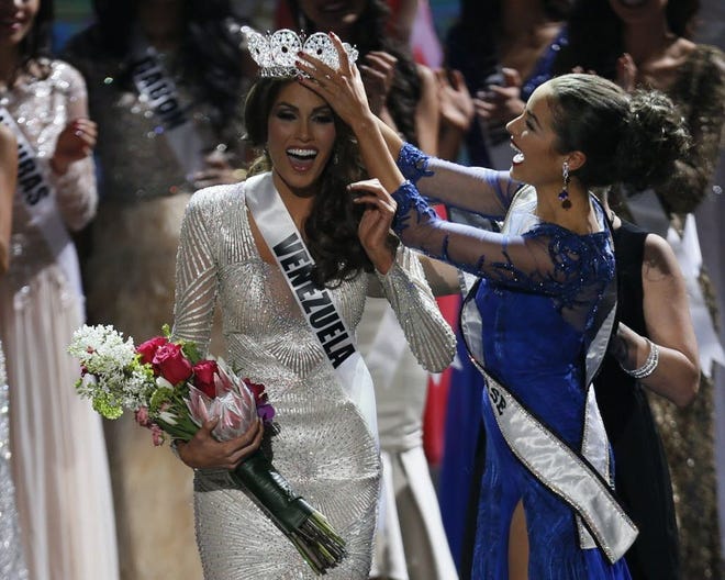 Miss Universe 2012 Olivia Culpo, right, places the crown on Miss Venezuela Gabriela Isler during the 2013 Miss Universe pageant. AP Photo, file / Pavel Golovkin