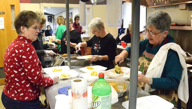 From left, Pat Geyer, Ann Lester and Betty Robertson serve a Christmas Community Meal Thursday at Mission Shawnee, 126 S. Center.