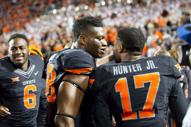 Oklahoma State Cowboys defensive end Emmanuel Ogbah (38) and cornerback Michael Hunter (17) celebrate after the game against the TCU Horned Frogs at Boone Pickens Stadium in Stillwater, Okla. on Saturday, Nov. 7, 2015. OSU won 49-29. (Rob Ferguson-USA TODAY Sports)