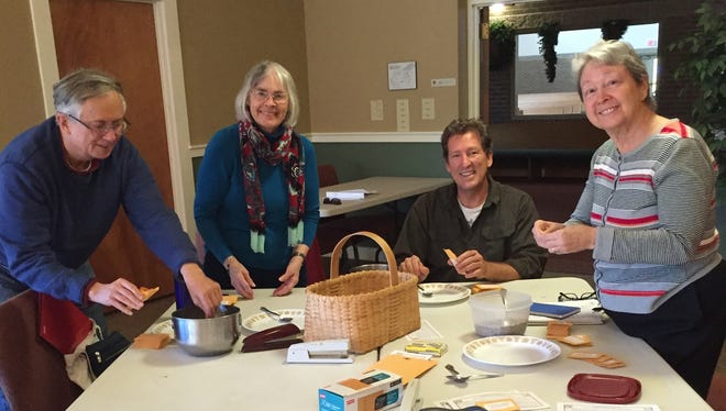 Members of the United Religions Initiative (URI) of Henderson County get ready for the 16th annual Interfaith Service for Peace by preparing a packet of seeds for each person who attends the Dec. service. The seed packets are the beginning of a personal garden of forgiveness, in keeping with this year's theme, "The Power of Forgiveness." Left to right, Chris Berg, Kitty Herriott, Lyndon Harris, Sandy Westin. Photo provided.