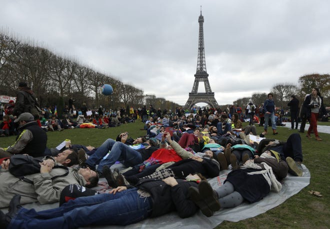 Activists stage a "die-in" as they protest near the Eiffel Tower in Paris on Dec. 12 during the United Nations Climate Change Conference. AP/Matt Dunham