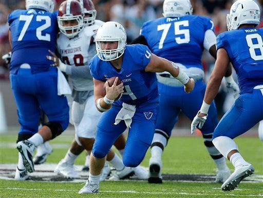 FILE - In this Sept. 12, 2015, file photo, Georgia State quarterback Nick Arbuckle, center, runs for yardage past the New Mexico State defense during the first half of an NCAA college football game in Las Cruces, N.M. Georgia State plays San Jose State in the Cure Bowl on Saturday. (AP Photo/Andres Leighton, File)