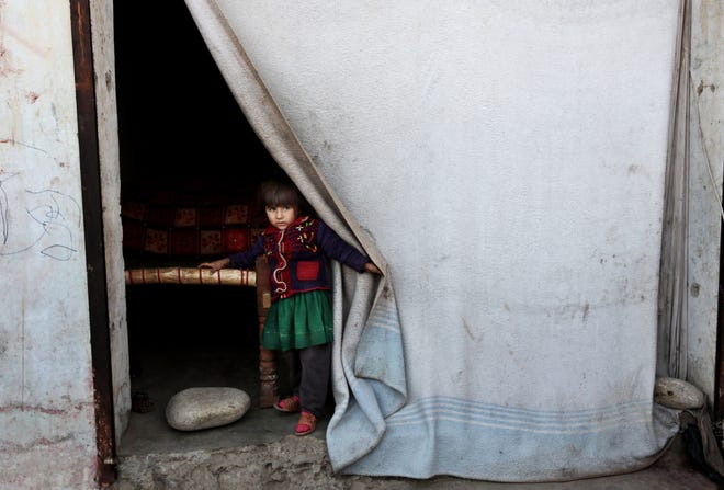 A displaced girl peers through the curtain of her temporary home after her family left their village in Rodat district of Jalalabad east of Kabul, Afghanistan. Nangarharís chief refugee official, Ghulam Haidar Faqirzai, said that at least 25,200 families, or more than 170,000 people, have been displaced across the province, either by Islamic State militants or by perceived threats from the group. As the winter sets in, the relief needs of the displaced are intensifying. The Associated Press