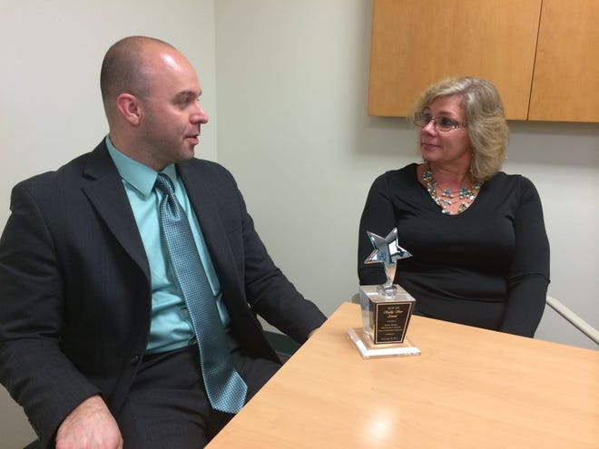 Delanco Superintendent Joseph Mersinger discusses the "Safety Star of the Year" award with recipient Karen Hozier. The district also netted $8,500 at a recent awards dinner for its commitment to safety.