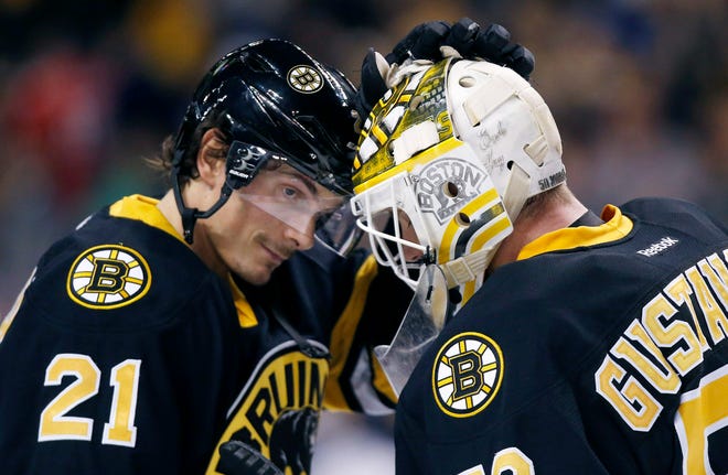 Boston Bruins forward Loui Eriksson (21) celebrates with teammate Jonas Gustavsson (50) after the Bruins defeated the New Jersey Devils, 2-1, in a shootout in Boston Sunday. Photo by AP