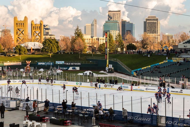 The Sacramento skyline can be seen in the distance as the Stockton Heat and Bakersfield Condors warm up for the first AHL outdoor game held in the western United States on Saturday at Raley Field. TRACY BARBUTES/FOR THE RECORD