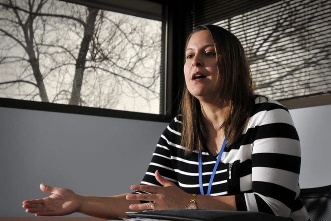 Ivelisse Delgado, reception/benefits supervisor, discusses health insurance issues during an interview at the Edward M. Kennedy Community Health Center on Lincoln Street in Worcester. T&G Staff/Paul Kapteyn