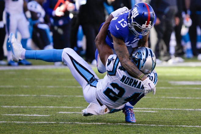 Giants' Odell Beckham (13) and Panthers' Josh Norman go at it during the first half on Sunday. The Associated Press