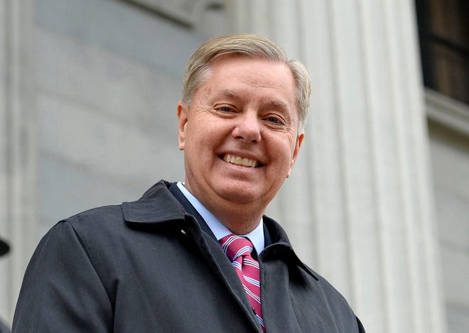 FILE - In this Jan. 14, 2015 file photo, Sen. Lindsey Graham, R- S.C., walks down the steps of the State Capitol building in Columbia, S.C. Republican presidential candidate Lindsey Graham has announced Monday he is ending his bid for the GOP nomination. (AP Photo/Richard Shiro)