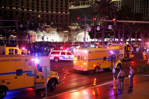 Police and emergency crews respond to the scene of an incident along Las Vegas Boulevard Sunday in Las Vegas. A woman intentionally swerved her car onto a busy sidewalk two or three times Sunday and mowed down people outside a casino, killing one person and injuring at least 30 others, police said.