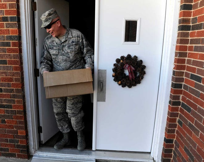 ADVANCE FOR USE MONDAY, DEC. 21 - In this photo taken Tuesday, Dec. 8, 2015, Chief Master Sgt. Vincent Miller, of the 317th Maintenance Squadron, helps carry boxes of snack items at United Methodist Church in Novice, Texas. Volunteers at the church organized the gifts for airmen from Dyess Air Force Base who are deployed overseas at Christmas. (Ronald W. Erdrich/The Abilene Reporter-News via AP) MANDATORY CREDIT