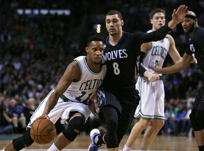 Celtics guard Evan Turner (left) tries to drive around Timberwolves guard Zach LaVine early in Boston's 113-99 win on Monday night.