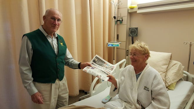 Bill Masterson makes his rounds of York Hospital rooms every Wednesday morning, offering patients a local newspaper. Here, he is handing one to Peg Hurd of Milton, NH. 

Photo by Deborah McDermott