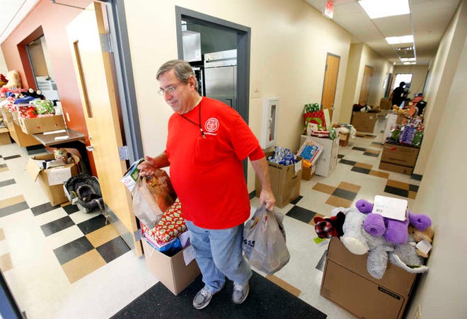 DARON.DEAN@STAUGUSTINE.COM Dave Kirschbaum carries bags of groceries from the St. Johns County Fire Rescue Command Center to an awaiting car Monday, December 21, 2015.