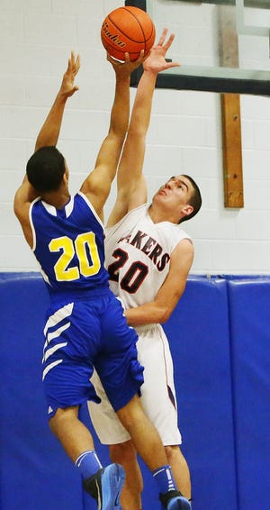 Apponequet's Wes Pinto, right, goes for the block on Wareham's Jamiell Martin. Apponequet beat Wareham, 75-66. MIKE VALERI/THE STANDARD-TIMES/SCMG