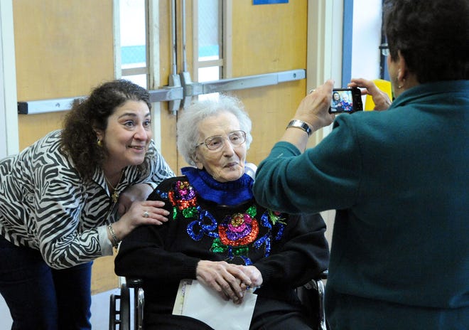 Sherry Oslick, left, poses with her grandmother Irene Economos at a party to celebrate her 100th birthday at Friendship Ridge Sunday. The party was attended by 70 family members and friends.