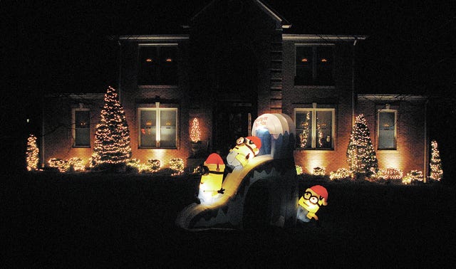 Look out! It’s a Minions Christmas as these three frolic on the front lawn with the backdrop of the beautiful lighting of this Claremont Drive home.