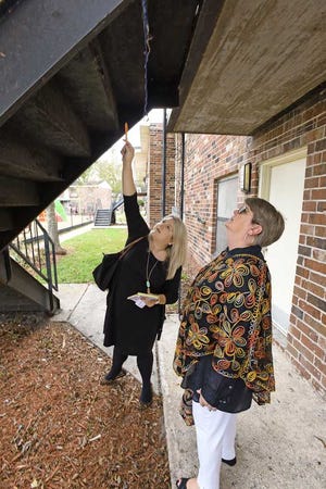 Bob.Self@jacksonville.com--12/22/15--(left) Ashley Cook, Special Assistant and Adele Griffin, the North Florida Regional Director for U.S. Senator Marco Rubio look at one of the stairways at Eureka Garden that had rust holes covered with black tape during a visit to the complex Tuesday. Representatives from U.S. Senator Marco Rubio's Jacksonville office talked with residents of Eureka Garden housing complex Tuesday afternoon, December 22, 2015 to assess what had been done at the problem plagued complex and get a better understanding of the issues that still exist. (The Florida Times-Union/Bob Self)