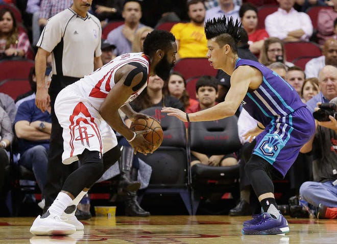 Houston Rockets guard James Harden (13) looks to dribble around Charlotte Hornets guard Jeremy Lin (7) in the first half of an NBA basketball game Monday, Dec. 21, 2015, in Houston.(AP Photo/Bob Levey)