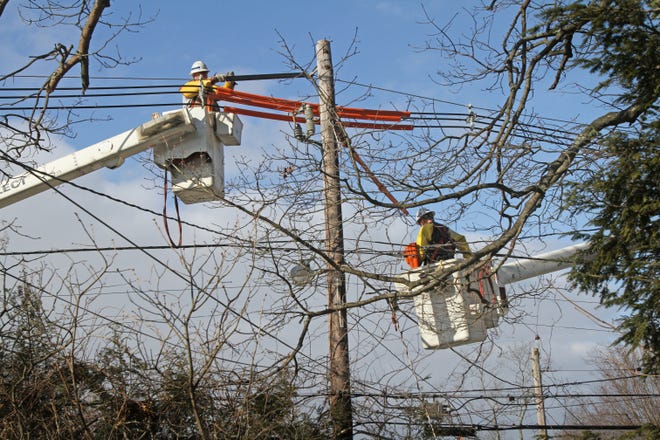 A National Grid crew installs a device that prevents service disruption in the event of a lightning strike in Coventry in February 2013. The Providence Journal files/Andrew Dickerman
