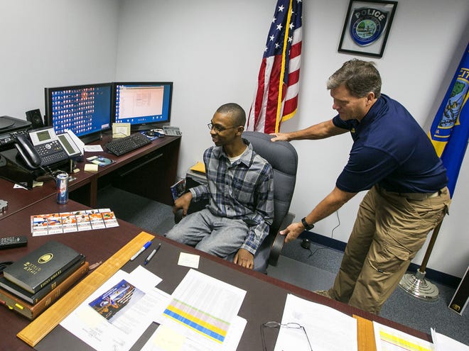 Bruce Blanford tries out Chief of Police Greg Graham's chair as he gets a tour of the Ocala Police Department.