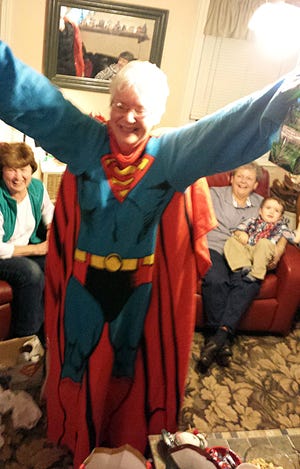A pre-Christmas Yankee Swap, hosted by Donna and Peter Hamel in Newmarket, brought out the Supergirl in Cammy Miller thanks to this snuggy.