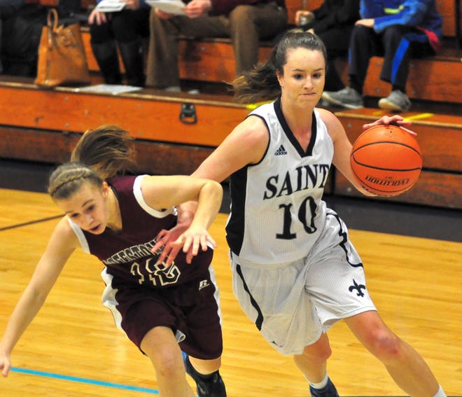 St. Thomas's Ashley Coneys, right, pushes off and fouls Goffstown's Gabriele Cass en route to the basket during Division II action Wednesday night at STA. Mike Whaley/Fosters.com