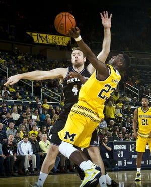 Bryant's Andrew Scocca defends against Michigan's Caris LeVert (23) on Wednesday night.