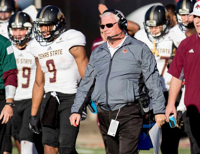 Texas State head coach Dennis Franchione walks out to visit his offense during a timeout during the first half half of an NCAA college football game against Arkansas State Saturday, Dec. 5, 2015, in Jonesboro, Ark. (AP Photo/Gareth Patterson)