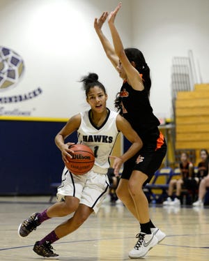 Silverado's Ronnae Green drives the ball against Apple Valley in the second day of the Serrano Holiday Classic. (Jose Huerta, Daily Press)