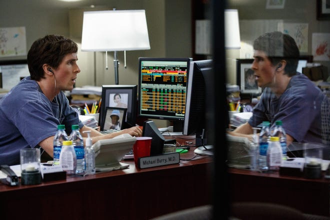 Brilliant fund manager Michael Burry (Christian Bale) listens to metal music while crunching numbers in “The Big Short.” (Paramount Pictures).