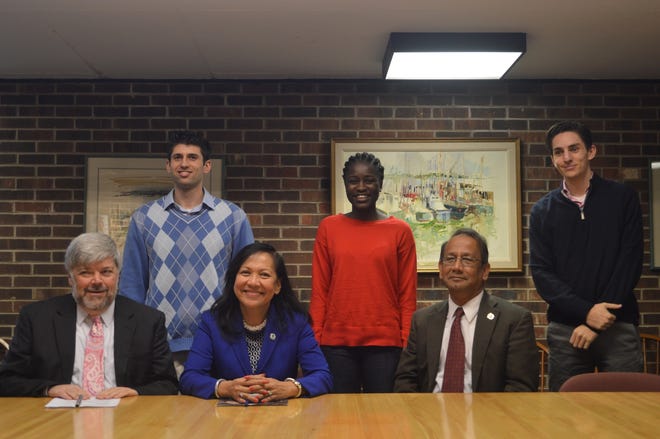 UMass Dartmouth and Cape Cod Community College officials sign a deal to offer a $30,000 bacheor’s degree at CCCC’s Nickerson Administative Building Board Room last week. From left, President John Cox, Chancellor Divina Grossman, UMass Dartmouth Provost Mohammad Karim and CCCC students. COURTESY PHOTO