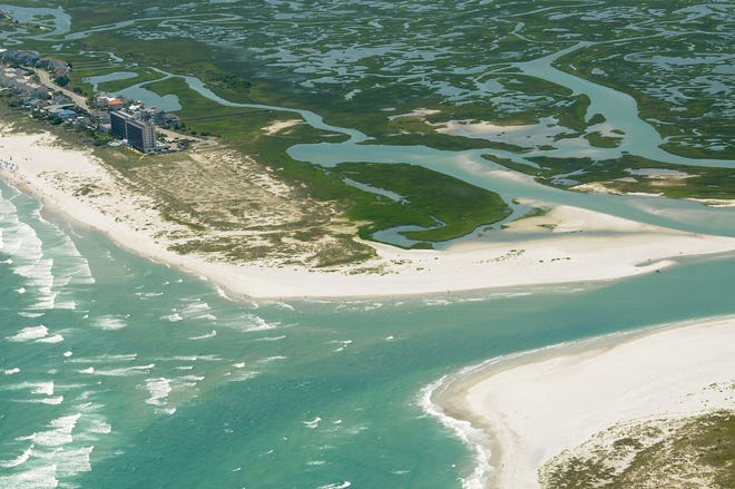 A June aerial photo of Mason Inlet with the Shell Island Resort visible in the distance. New Hanover County has approved a contract to dredge the inlet so it doesn't again threaten structures at the north end of Wrightsville Beach. Photo By Ken Blevins/ StarNews Media