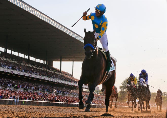 Victor Espinoza reacts after crossing the finish line with American Pharoah to win the Belmont Stakes in Elmont on June 6. American Pharoahís sweep of the Kentucky Derby, Preakness and Belmont Stakes for horse racing's first Triple Crown since 1978 and was selected the sports story of the year Thursday by the Associated Press. Associated Press